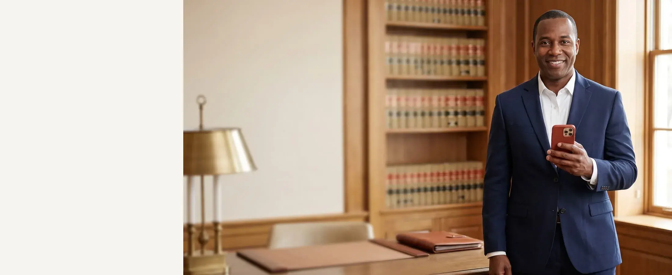 Attorney standing in a law office with a phone in hand